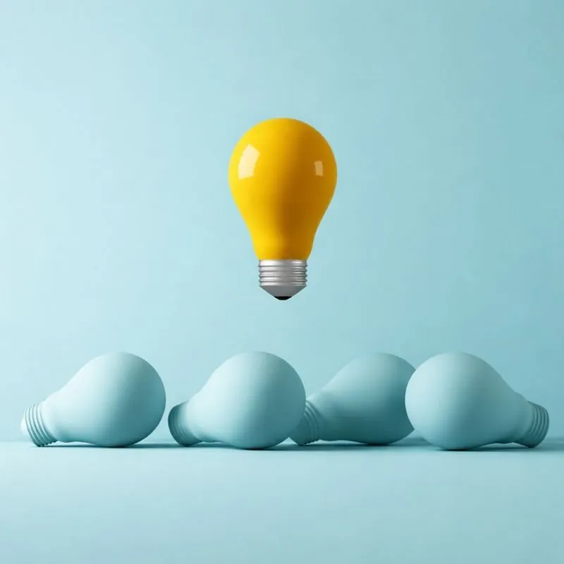 A lit yellow bulb above a row of blue bulbs