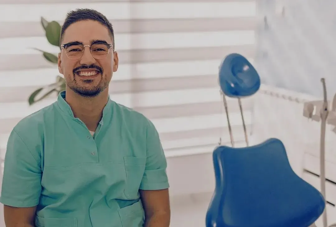 Smiling dentist in a modern operatory