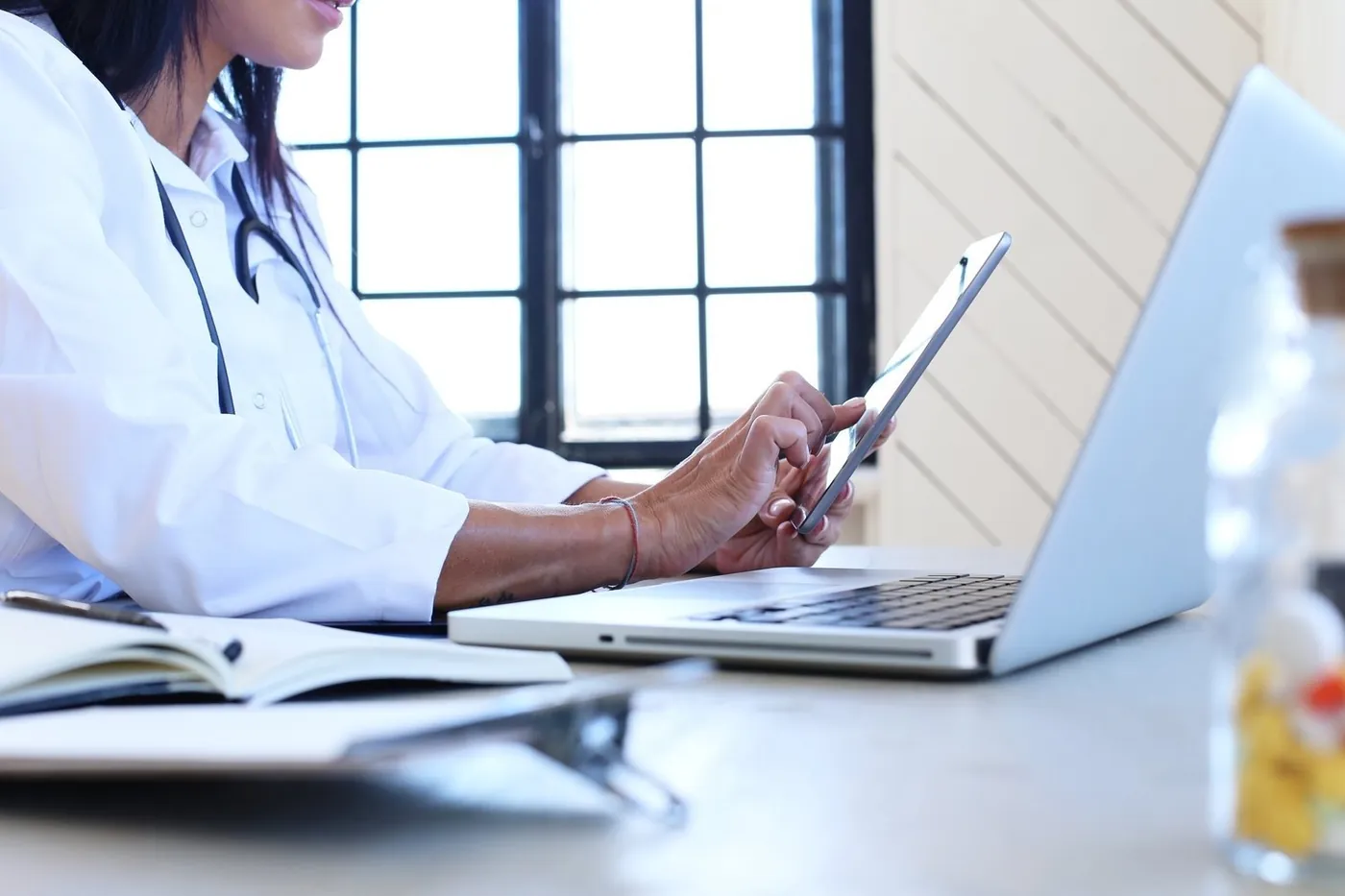 Doctor reviewing patient emails on a laptop
