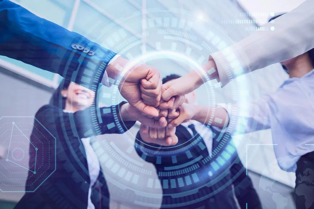 Team hands joined over a digital interface